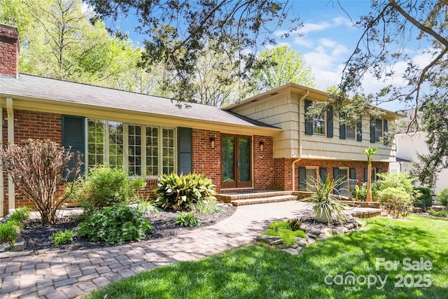 6921 Thermal Rd, Charlotte, NC 28211 - tri-level home featuring brick siding, a chimney, and a front yard