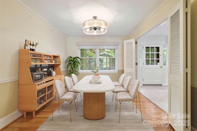 6921 Thermal Rd, Charlotte, NC 28211 - dining space with healthy amount of natural light, ornamental molding, a chandelier, and light wood-style floors