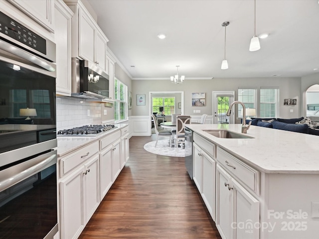 15614 Aviary Orchard Way, Charlotte, NC 28278 - kitchen featuring appliances with stainless steel finishes, a chandelier, white cabinetry, hanging light fixtures, and dark wood finished floors