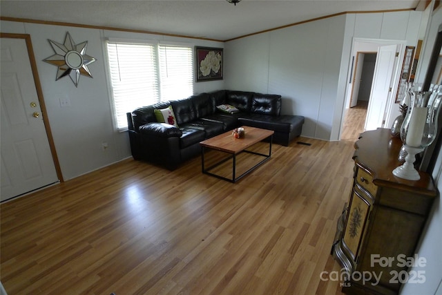 236 Boxwood Church Rd, Mocksville, NC 27028 - living room featuring crown molding, light wood-style flooring, and a decorative wall