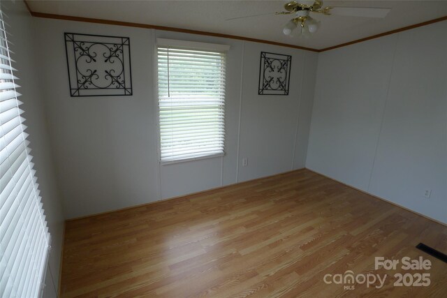 236 Boxwood Church Rd, Mocksville, NC 27028 - spare room featuring wood finished floors, ornamental molding, and a ceiling fan