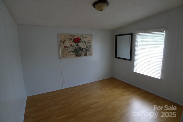 236 Boxwood Church Rd, Mocksville, NC 27028 - unfurnished room featuring wood finished floors, vaulted ceiling, and a textured ceiling