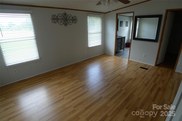 236 Boxwood Church Rd, Mocksville, NC 27028 - unfurnished bedroom with ornamental molding, light wood-style flooring, and a ceiling fan