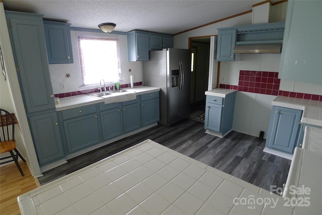 236 Boxwood Church Rd, Mocksville, NC 27028 - kitchen with stainless steel fridge with ice dispenser, blue cabinetry, tile countertops, dark wood finished floors, and a textured ceiling