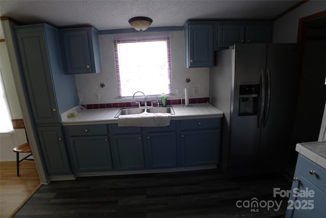 236 Boxwood Church Rd, Mocksville, NC 27028 - kitchen with stainless steel fridge with ice dispenser, tile counters, blue cabinets, dark wood-style floors, and a textured ceiling