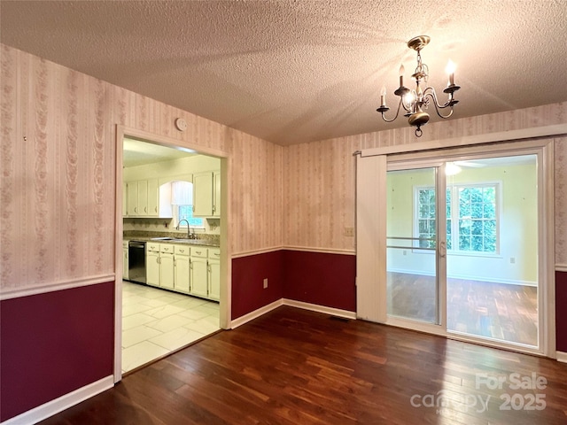 1164 Hidden Lake Dr Unit 10, Granite Falls, NC 28630 - unfurnished dining area featuring a textured ceiling, dark wood-style floors, a chandelier, and wallpapered walls