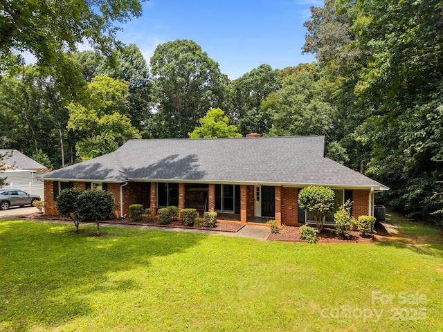 324 Swamp Fox Dr, Fort Mill, SC 29715 - ranch-style house with brick siding, a shingled roof, a front lawn, and a chimney