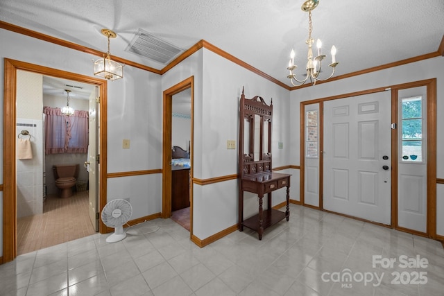 324 Swamp Fox Dr, Fort Mill, SC 29715 - foyer featuring a chandelier, crown molding, and a textured ceiling