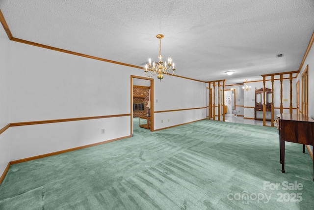 324 Swamp Fox Dr, Fort Mill, SC 29715 - carpeted spare room featuring a chandelier, a textured ceiling, crown molding, and a brick fireplace