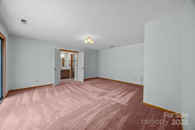 324 Swamp Fox Dr, Fort Mill, SC 29715 - unfurnished bedroom featuring light colored carpet, a textured ceiling, and ensuite bath