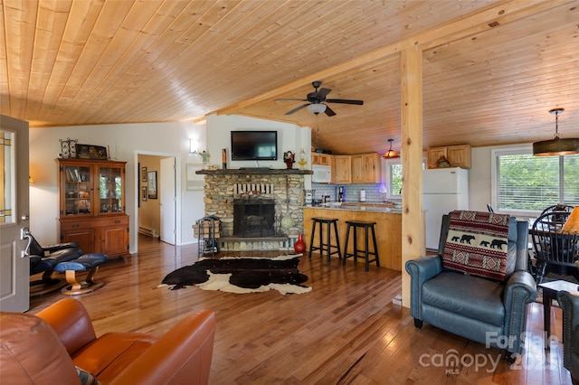 56 Faraway Dr, Cullowhee, NC 28723 - living room with wooden ceiling, wood finished floors, ceiling fan, a baseboard heating unit, and a stone fireplace