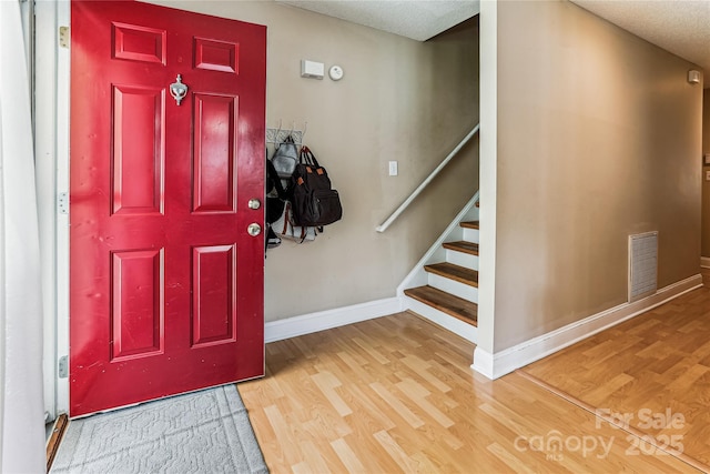 2040 Brantley Creek Dr, Kannapolis, NC 28083 - entrance foyer with wood finished floors, a textured ceiling, and stairway