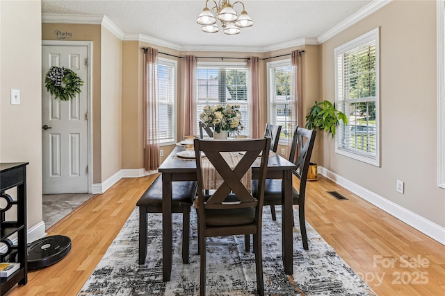 2040 Brantley Creek Dr, Kannapolis, NC 28083 - dining room with a chandelier, light wood-type flooring, crown molding, and a textured ceiling