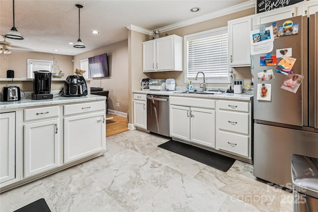 2040 Brantley Creek Dr, Kannapolis, NC 28083 - kitchen with appliances with stainless steel finishes, crown molding, light countertops, white cabinetry, and pendant lighting