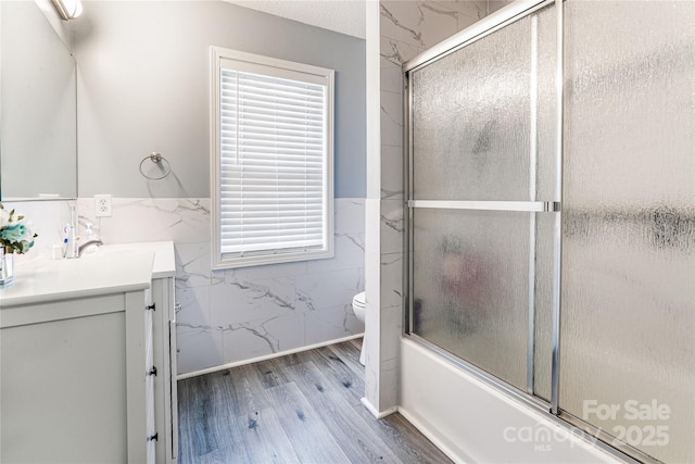2040 Brantley Creek Dr, Kannapolis, NC 28083 - full bathroom with tile walls, vanity, wood finished floors, enclosed tub / shower combo, and wainscoting