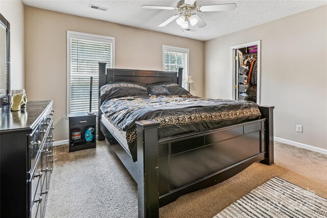 2040 Brantley Creek Dr, Kannapolis, NC 28083 - bedroom with carpet flooring, a textured ceiling, a walk in closet, ceiling fan, and a closet