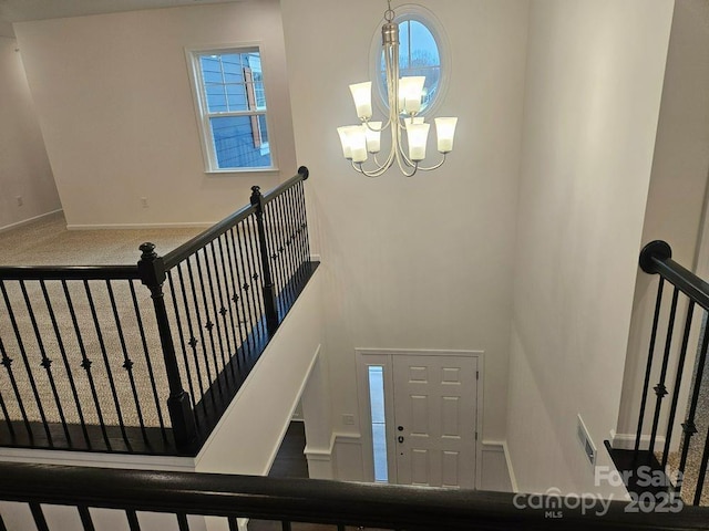 8231 Annsborough Dr NW, Concord, NC 28027 - stairs with a chandelier and baseboards