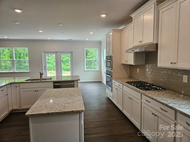 8231 Annsborough Dr NW, Concord, NC 28027 - kitchen with gas stovetop, under cabinet range hood, plenty of natural light, dishwasher, and recessed lighting