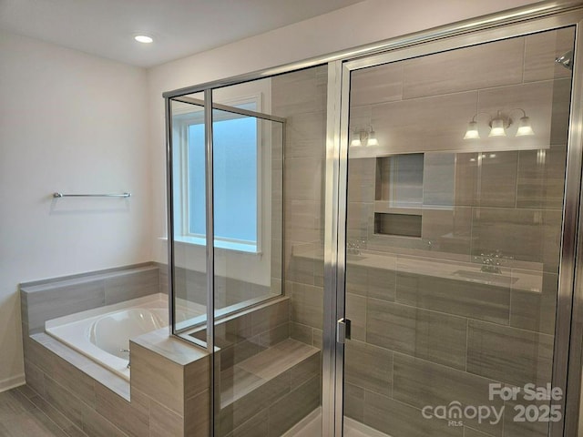 8231 Annsborough Dr NW, Concord, NC 28027 - bathroom with a shower stall, a garden tub, and recessed lighting