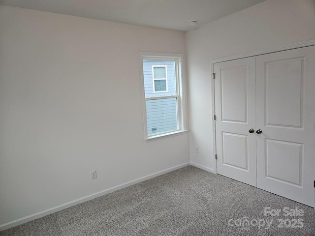8231 Annsborough Dr NW, Concord, NC 28027 - unfurnished bedroom with carpet floors and a closet