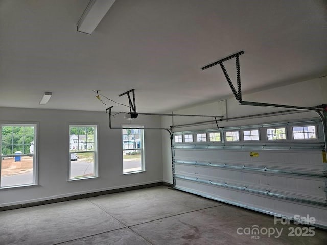 8231 Annsborough Dr NW, Concord, NC 28027 - garage featuring baseboards and a garage door opener