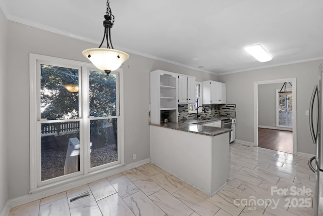 6017 Millbury Ct, Charlotte, NC 28211 - kitchen featuring light marble finish floors, white cabinets, a peninsula, crown molding, and dark stone countertops