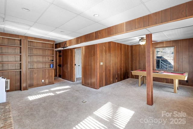 6017 Millbury Ct, Charlotte, NC 28211 - below grade area featuring wooden walls, carpet floors, a drop ceiling, and built in shelves