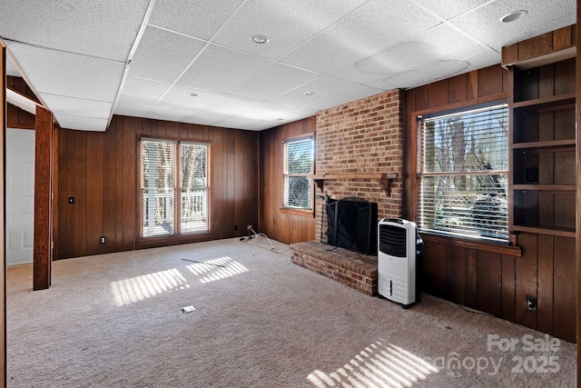 6017 Millbury Ct, Charlotte, NC 28211 - unfurnished living room with wood walls, carpet floors, and a fireplace