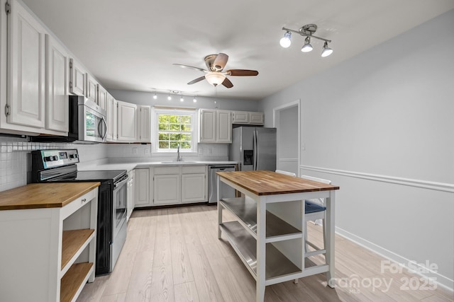 11329 Torino Rd, Matthews, NC 28105 - kitchen with wooden counters, open shelves, appliances with stainless steel finishes, and tasteful backsplash
