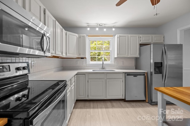 11329 Torino Rd, Matthews, NC 28105 - kitchen featuring stainless steel appliances, light countertops, decorative backsplash, light wood-style flooring, and ceiling fan
