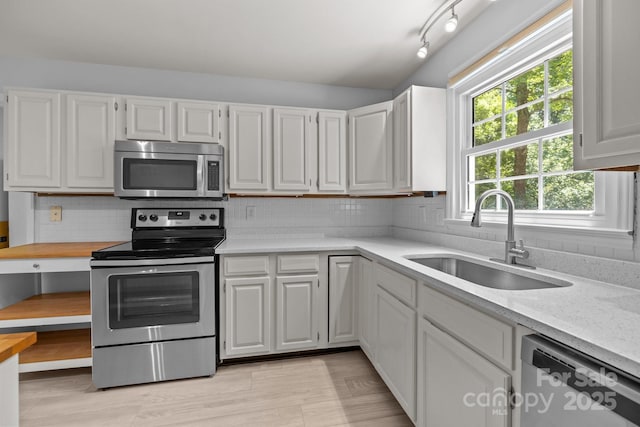 11329 Torino Rd, Matthews, NC 28105 - kitchen featuring appliances with stainless steel finishes, white cabinetry, and tasteful backsplash