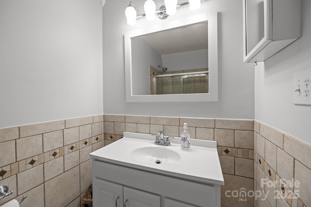11329 Torino Rd, Matthews, NC 28105 - bathroom featuring vanity, tile walls, wainscoting, and a shower
