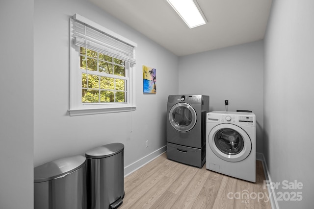 11329 Torino Rd, Matthews, NC 28105 - washroom with washing machine and clothes dryer and light wood finished floors