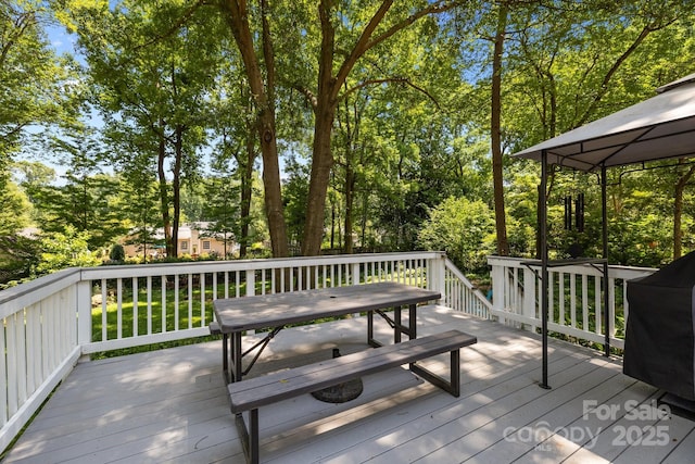 11329 Torino Rd, Matthews, NC 28105 - wooden terrace with area for grilling, a gazebo, and view of wooded area
