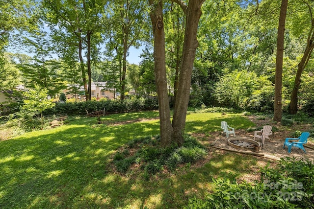 11329 Torino Rd, Matthews, NC 28105 - view of grassy yard featuring an outdoor fire pit