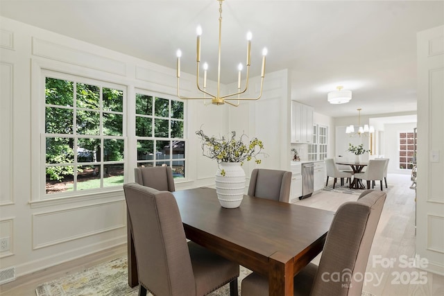 811 Ashmeade Rd, Charlotte, NC 28211 - dining space featuring a chandelier and light wood-style flooring