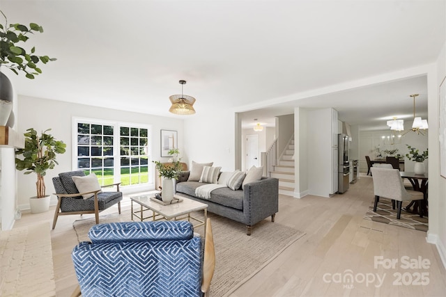 811 Ashmeade Rd, Charlotte, NC 28211 - living area with stairway, light wood-type flooring, and a chandelier