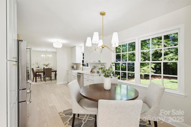 811 Ashmeade Rd, Charlotte, NC 28211 - dining space featuring a chandelier, light wood-style floors, and healthy amount of natural light