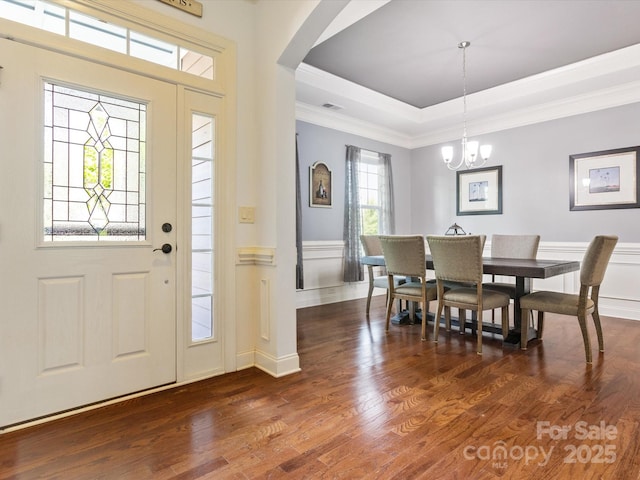 1009 Hampton Grove Rd, Waxhaw, NC 28173 - entrance foyer with arched walkways, crown molding, a chandelier, a raised ceiling, and dark wood-type flooring