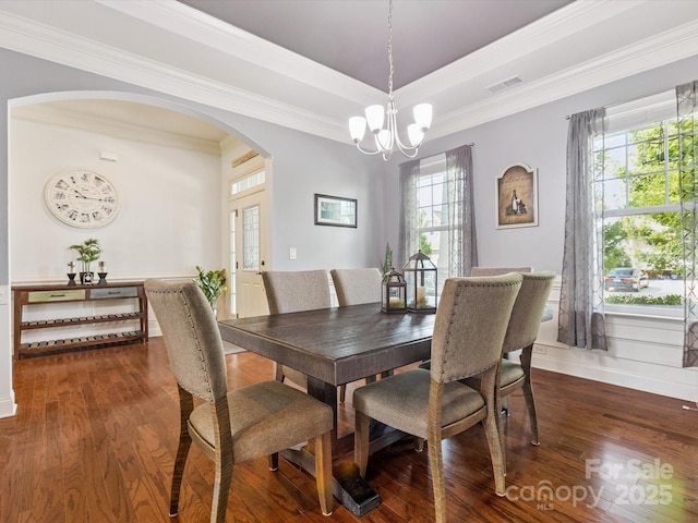 1009 Hampton Grove Rd, Waxhaw, NC 28173 - dining area featuring arched walkways, a chandelier, dark wood finished floors, and crown molding