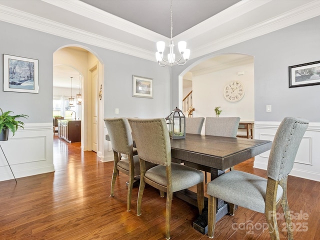 1009 Hampton Grove Rd, Waxhaw, NC 28173 - dining area with arched walkways, a chandelier, wood finished floors, a decorative wall, and ornamental molding