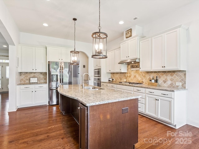 1009 Hampton Grove Rd, Waxhaw, NC 28173 - kitchen featuring arched walkways, decorative backsplash, dark wood finished floors, appliances with stainless steel finishes, and recessed lighting
