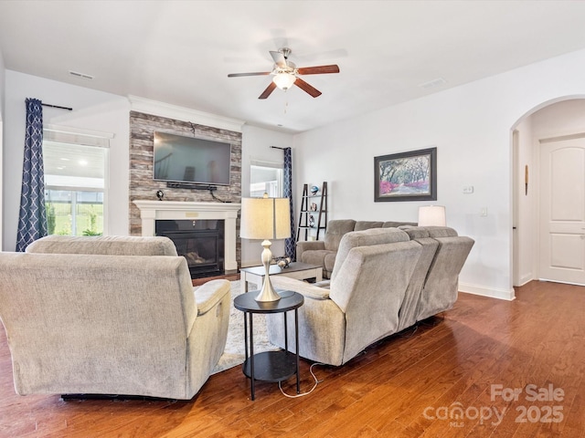 1009 Hampton Grove Rd, Waxhaw, NC 28173 - living room with a ceiling fan, wood finished floors, arched walkways, and a glass covered fireplace