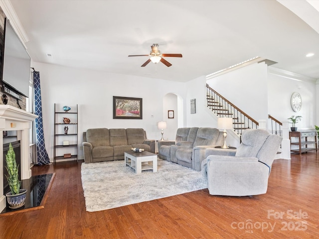 1009 Hampton Grove Rd, Waxhaw, NC 28173 - living room featuring arched walkways, a ceiling fan, wood finished floors, stairs, and a fireplace