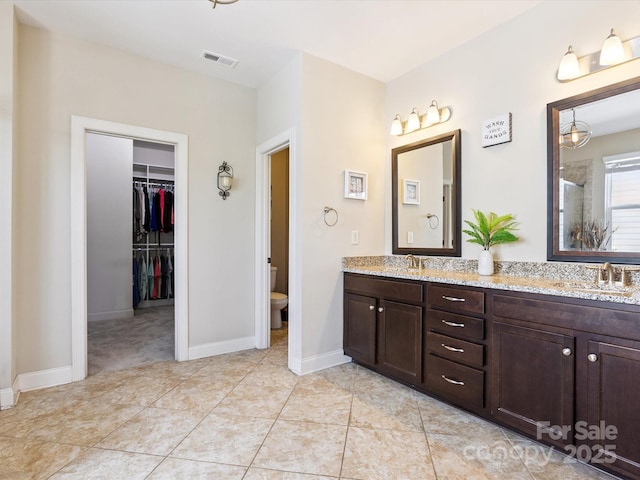 1009 Hampton Grove Rd, Waxhaw, NC 28173 - full bathroom featuring double vanity, an enclosed shower, a spacious closet, and tile patterned flooring