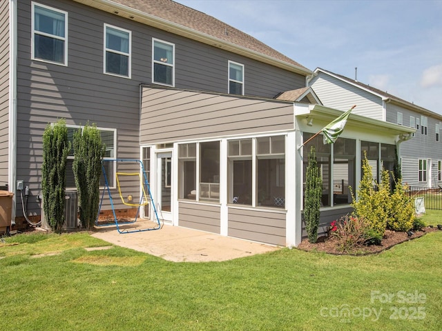 1009 Hampton Grove Rd, Waxhaw, NC 28173 - back of house with a sunroom, a lawn, a patio, and roof with shingles