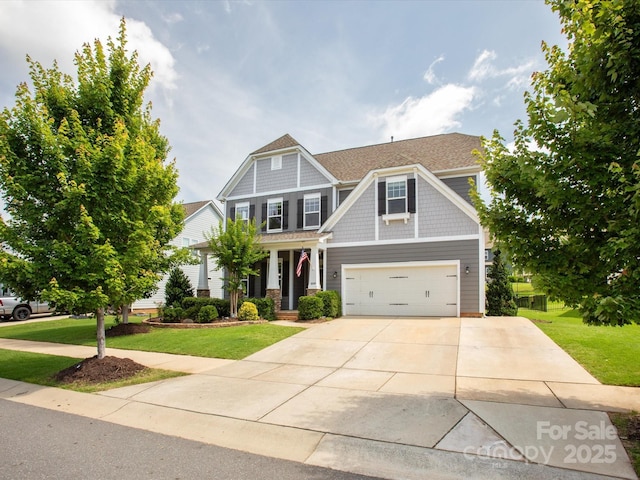 1009 Hampton Grove Rd, Waxhaw, NC 28173 - craftsman-style house featuring a front yard, concrete driveway, a garage, and covered porch
