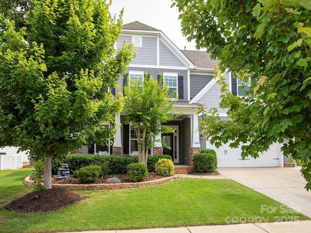 1009 Hampton Grove Rd, Waxhaw, NC 28173 - view of front facade with concrete driveway, a front yard, a garage, and a shingled roof