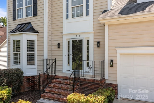4519 Rock Stream Dr, Charlotte, NC 28269 - doorway to property featuring a garage and a shingled roof