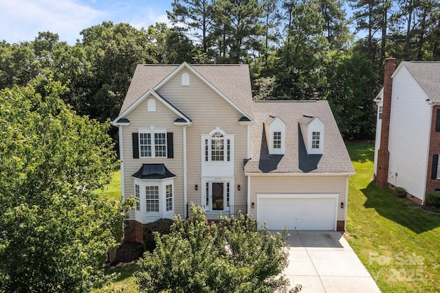 4519 Rock Stream Dr, Charlotte, NC 28269 - traditional-style home with concrete driveway, roof with shingles, a front lawn, an attached garage, and view of scattered trees